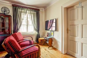 a living room with a chair and a window at Apartment Julijan in Varaždin