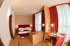 a hotel room with a bed and a desk at B&B HOTEL Remilia in Reggio Emilia