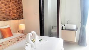 a hotel room with a bed with a swan decoration on it at The Wings Boutique Hotels Krabi Ko Lanta in Ko Lanta +176 photos