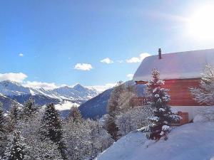 a barn with snow on the side of it in the mountains at Comfortable Holiday Home with Fireplace in Vex in Les Collons