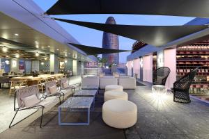 a restaurant with chairs and tables and a skyline at Hotel SB Glow Sup in Barcelona