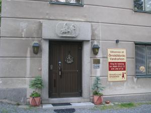 a building with a door with a sign on it at Örnsköldsviks Vandrarhem in Örnsköldsvik