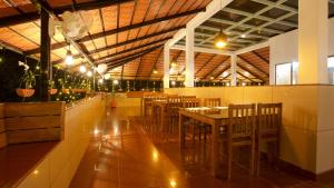 a dining room with tables and chairs in a building at Roses Inn Fortkochi in Cochin