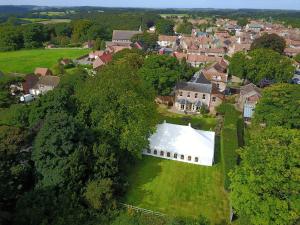 an aerial view of a large white building in a village at The Lawns Spa Apartment in Holt