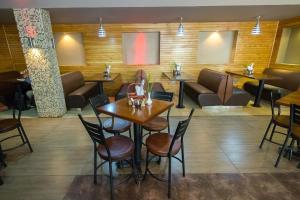 a restaurant with tables and chairs and couches at Victoria Comfort Inn in Kisumu