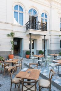 a patio with tables and chairs in front of a building at Smokvica Dorćol B&B in Belgrade