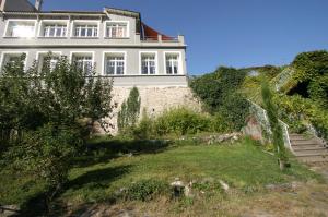 a white house on a hill with a yard at Maison Mauro in Prats-de-Mollo-la-Preste