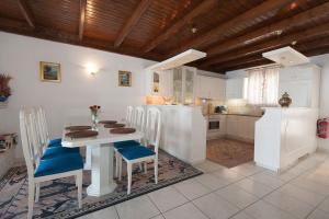 a kitchen with a table and chairs in a room at Sweet Memories Beach Houses in Mesongi