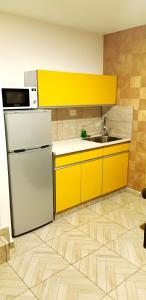 a kitchen with a refrigerator and a sink at City Suites in Eilat