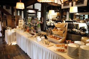 a long white table with plates and food on it at Hof Hueck in Bad Sassendorf