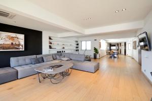 a living room with a couch and a table at Hidesign Athens Art Loft Penthouse Acropolis View in Athens