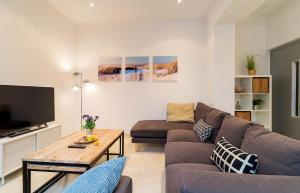 a living room with a couch and a table at Beach Town House in Vilassar de Mar