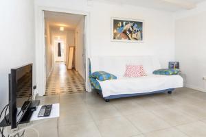 a living room with a couch and a television at Private Roof Top Sant Antoni in Barcelona