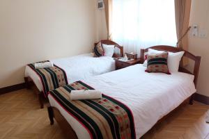 Ein Bett oder Betten in einem Zimmer der Unterkunft Latisha House