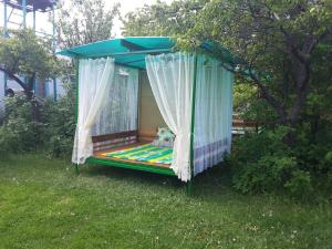 a bed in a tent in a yard at Guest house Elena in Kaji-Say