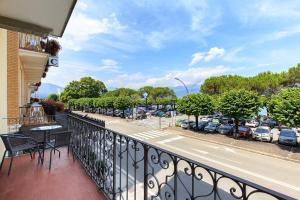 a balcony with a view of a parking lot at La Promenade by Impero House in Stresa