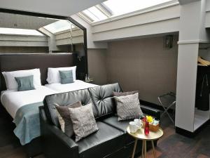 a hotel room with a couch and a bed at Camden Enterprise Hotel in London