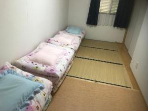 Postel nebo postele na pokoji v ubytování Guest House Iwato