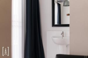 a bathroom with a sink and a mirror at i-river chiangmai in Chiang Mai