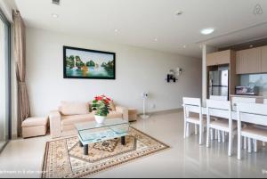 a living room with a couch and a table at Ocean Apartment in Danang