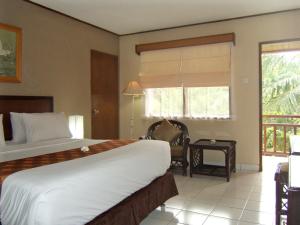 Voodi või voodid majutusasutuse The Jayakarta Yogyakarta Hotel & Spa toas