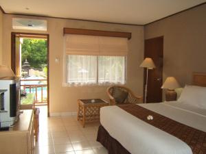 Voodi või voodid majutusasutuse The Jayakarta Yogyakarta Hotel & Spa toas