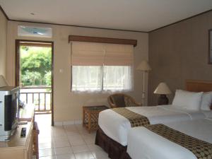 Voodi või voodid majutusasutuse The Jayakarta Yogyakarta Hotel & Spa toas