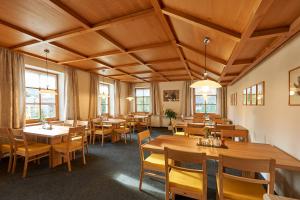 a dining room with wooden tables and chairs at Seminar- und Gästehaus im Kloster Bezau in Bezau