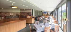 a dining room with tables and chairs and a restaurant at Aktiv & Genusshotel Lodenwirt in Vandoies