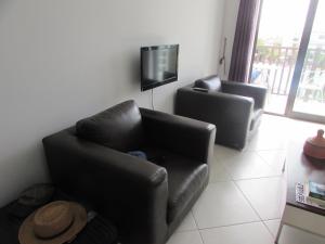 a living room with a couch and a tv at BCV Private 2 Bed Penthouse Apartment With Pool View Dunas Resort 1145 in Santa Maria