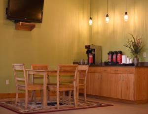 a dining room with a table and chairs at Champions Black Bear Lodge in Delhi