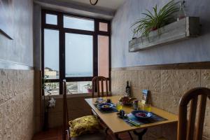 a dining room with a table and a window at Seaview Faro Arinaga in Arinaga