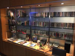 a book shelf filled with books and dvds at Hotel Franklin Feel The Sound in Rome