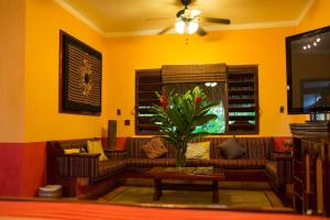 a living room filled with furniture and a fire place at Hotel Boutique Quinta Chanabnal in Palenque