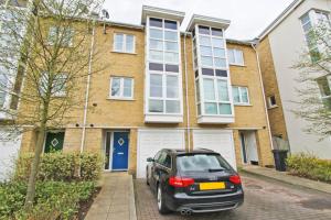 a small car parked in front of a house at Sunnybank House in North Epsom in Epsom