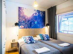 Postel nebo postele na pokoji v ubytování Haapala Suites entinen IIDA Vuokatti