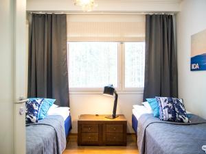 Postel nebo postele na pokoji v ubytování Haapala Suites entinen IIDA Vuokatti