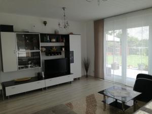 a living room with a large television and a table at Marina in Bleckede +8 photos
