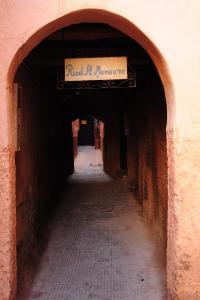 an alley with a sign that reads dried up romance at Riad Al Mamoune in Marrakesh