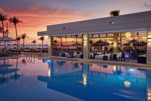 a resort with a swimming pool at dusk at Bucuti & Tara Boutique Beach Resort - Adult Only in Palm-Eagle Beach