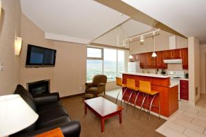 a room with a kitchen and a living room at Residence & Conference Centre - Kamloops in Kamloops