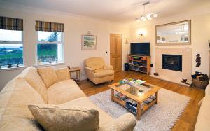 a living room with a couch and a coffee table at Muldoanich in Gairloch