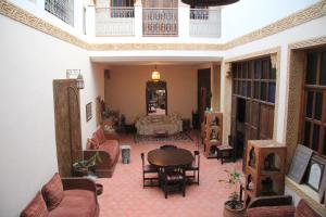 a large living room with a table and chairs at dar wassim el ghali in Rabat