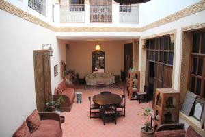 a living room filled with furniture and a large window at Riad Dar El Ghali in Rabat