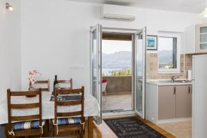 uma cozinha e sala de jantar com vista para as montanhas em Apartments Oliva em Cavtat