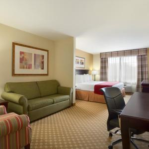 a hotel room with a bed and a couch at Spark by Hilton Washington Meadowlands Blvd in Washington