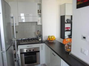 a kitchen with a stove top oven next to a refrigerator at Alloggio al Naviglio in Copparo