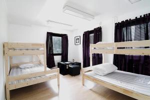 a room with three bunk beds in it at Hostel 10 in Gothenburg