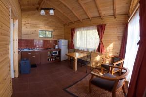 a kitchen and dining room with a table in a cabin at Eco Cabañas Algarrobo in Algarrobo