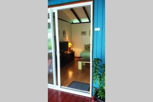 una puerta corredera de cristal que conduce a una sala de estar en Otemanu Ninamu Fare, en Bora Bora